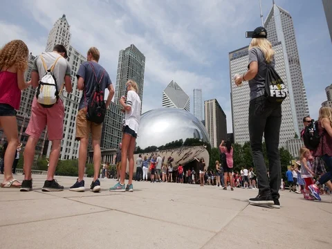 4k low angle tourists walking towards Chicago cloud gate the bean Stock Footage 78079938
