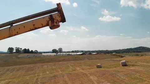 4K low angle view of farmland + grain auger + old hay wagon Stock Footage 116789724