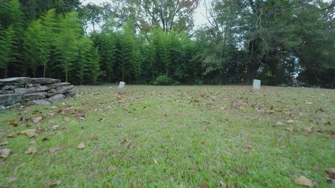 4K-Low Backaway-Between Two Vintage Country Burial Mounds Stock Footage 97902584