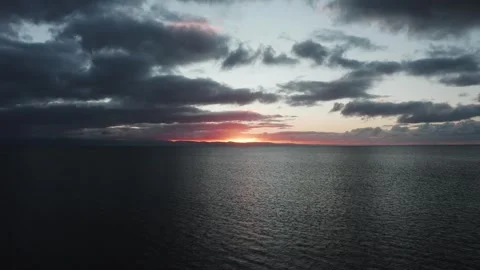 4K low drone flight over the sea during sunrise along the Welsh coast Видео 296804528