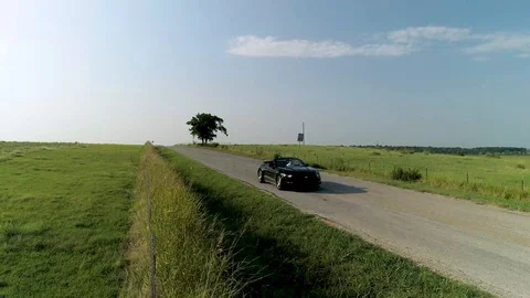 4K Low Fast Flying Pan Aerial Car on Rural Road Stock Footage 94000728