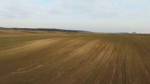 4K. Low flight above freshly cultivated fields in spring, aerial panoramic view. Video stock 73545371