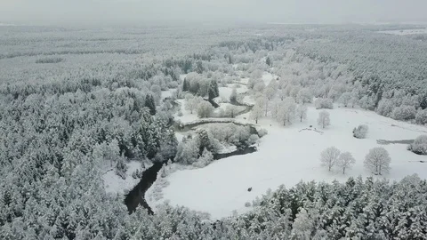 4K. Low flight above winding river in frozen forest at foggy weather. Aerial. Vídeo Stock 83403205