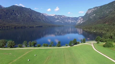 4K. Low flight and takeoff above amazing Bohinj Lake valley in the morning. Video stock 66131124
