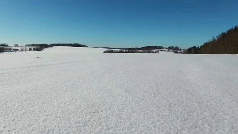 4K. Low flight and takeoff above snow fields in winter. Winter land in the north 스톡 동영상 72732116