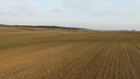4K. Low flight and takeoff above freshly cultivated fields in spring. Stock-Footage 73532023