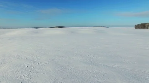 4K. Low flight and takeoff above snow fields in winter, aerial. Stock Footage 81721085
