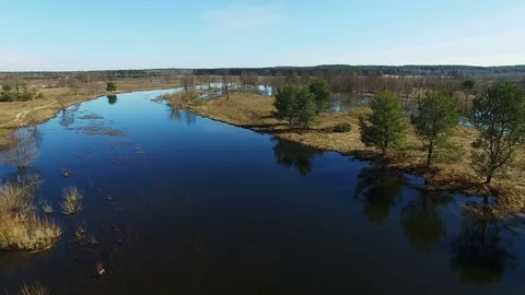 4K. Low flight and takeoff over flooded blue river in early spring, aerial view. Stock Footage 85039736