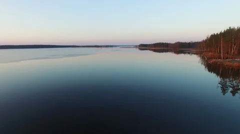 4K. Low flight over wild lake in early spring on sunset, aerial view. 動画素材 61738235