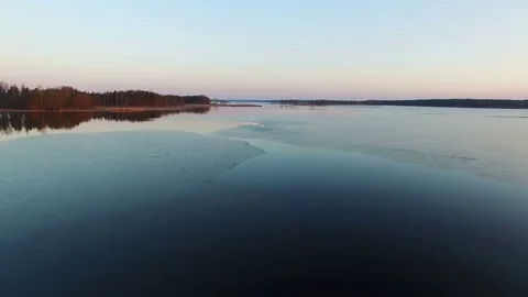 4K. Low flight over wild frozen lake in winter on sunset, aerial view. 스톡 동영상 82176304