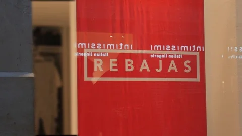 4k low light static shot of a sales sign in a window with reflections of people. Stock Footage 122646964