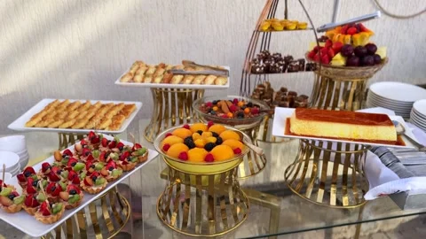 4K Luxury Dessert Buffet Spread with Mini Fruit Tarts, Baklava, Chocolate Bites Stock Footage 326031139