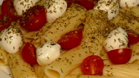 4k – Macaroni tubes with mozzarella, cherry tomatoes and spices on plate Stock Footage 56065269