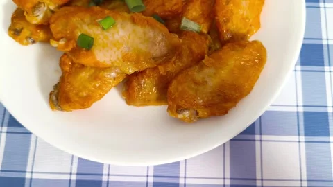 4K macro close up view of vibrant crispy hot fried chicken wings with slice.. Stock Footage 318253250