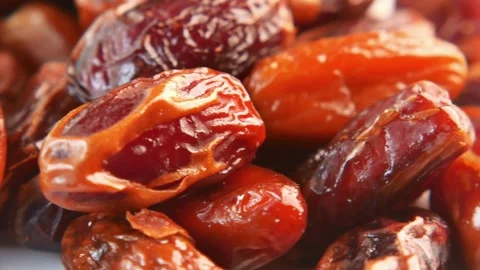 4K Macro of Ripe Medjool Dates Fruit on Rustic Wooden Plate 스톡 동영상 334443022