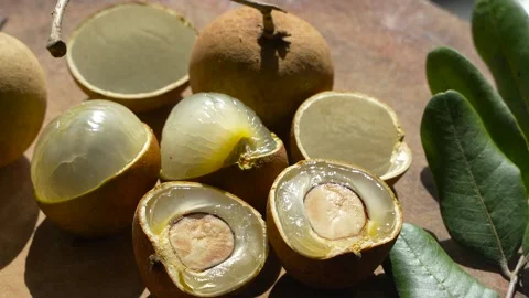 4K Macro: Sliced Longan Fruit from Vietnam Displaying Shiny Seed &amp; Pulp. Stock Footage 314951031