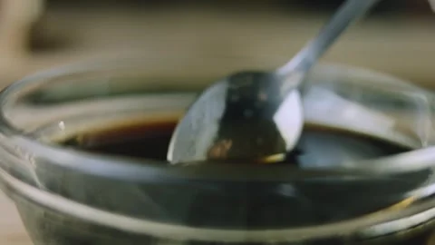 4K Macro Spoon Detail with Viscous Cola Syrup Dripping Back into a Bowl Video stock 342112952