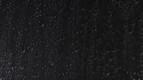 4K Macro Water Droplets On Black Surface Vertical Streaks High Contrast Stock Footage 334441250