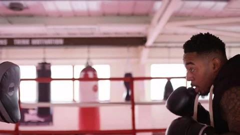 4K Male boxer training in the ring with pad work, in slow motion Stock-Footage 73143991
