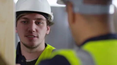 4k Male construction worker or tradesman working with male apprentice Stock Footage 54035234