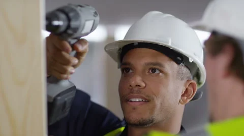4k Male construction worker or tradesman working with male apprentice Stock Footage 54037322
