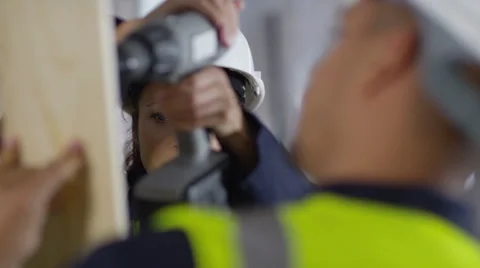 4k Male construction worker or tradesman working with female apprentice Stock Footage 54038764