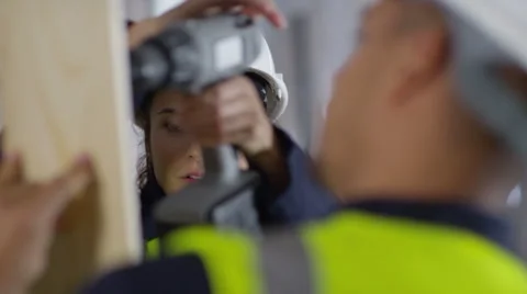 4k Male construction worker or tradesman working with female apprentice Stock Footage 54040721