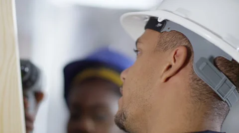 4k Male construction worker or tradesman working with female apprentice Stock Footage 54042387