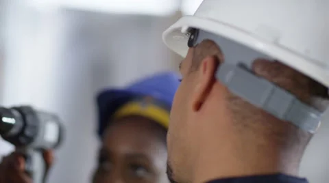 4k Male construction worker or tradesman working with female apprentice Stock Footage 54042515