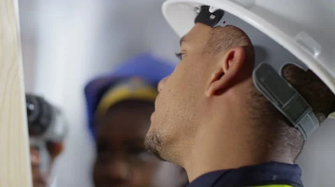 4k Male construction worker or tradesman working with female apprentice Stock Footage 54043257