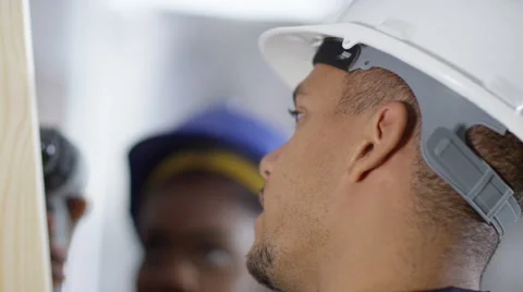 4k Male construction worker or tradesman working with female apprentice Stock Footage 54043302