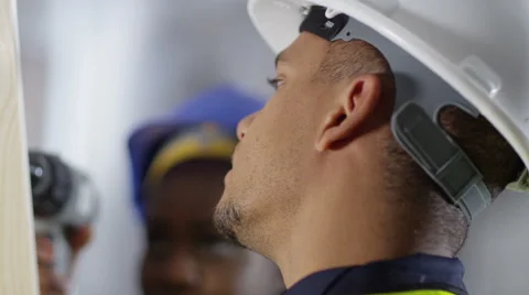 4k Male construction worker or tradesman working with female apprentice Stock Footage 54044172
