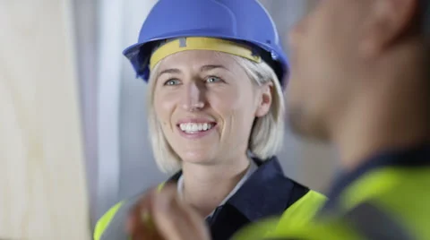 4k Male construction worker or tradesman working with female apprentice Stock Footage 54099701