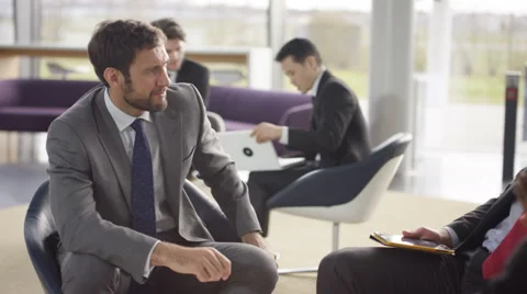 4K Male corporate business team in negotiation in busy modern office Stock Footage