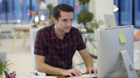4K Male designers looking at computer &amp; collaborating in creative office Stock Footage 76005693