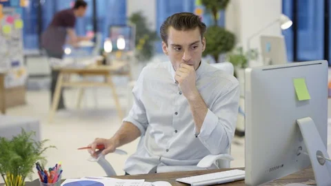 4K Male designers looking at computer &amp; collaborating in creative office Stock Footage 76006150