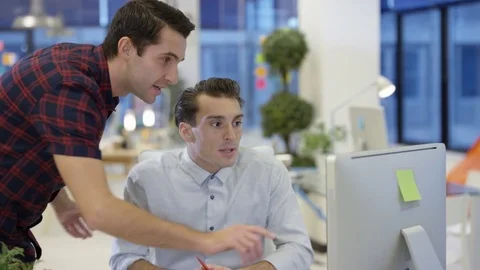 4K Male designers looking at computer &amp; collaborating in creative office Stock Footage 76006255