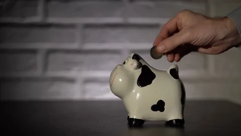 4K. Male hand close-up, throws coins, euros in the piggy Bank. Stock Footage 131348520