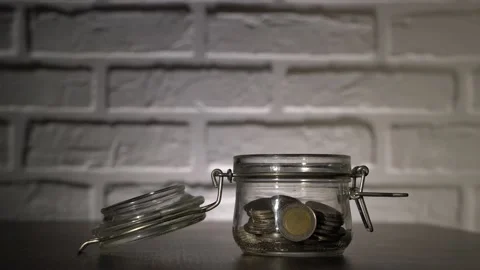 4K. Male hand close-up, throws coins, euros in the piggy Bank. Stock Footage 131348530