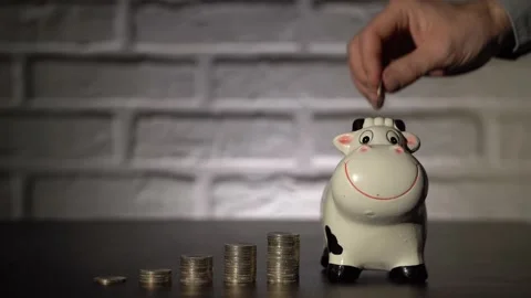 4K. Male hand close-up, throws coins, euros in the piggy Bank. Stock Footage 131348554