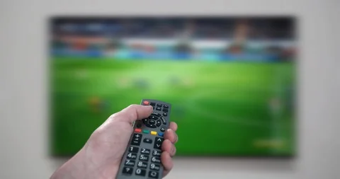 4K - Male hand using a remote control to change Tv channels Stock Footage 102160010