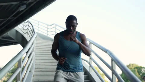 4k Male runner runs down bridge in city spbas. Stock Footage 219894096