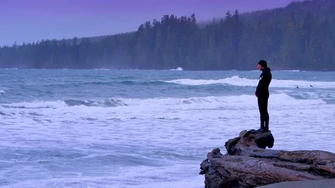 4K Man Alone on Drift Wood Log, White Foam and Surf, Waves and Wind Stock-Footage 72335433