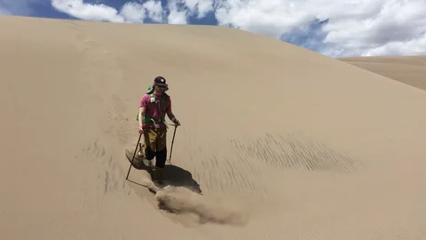4K Man Backpacking Through Desert Sand Dunes National Park Video stock 101000353