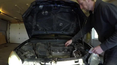 4k man checks car engine oil go pro view Stock Footage 61417974