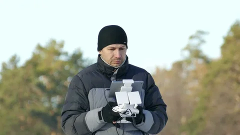 4K. Man with console for drone operate Radio transmitter System. Stockbeeldmateriaal 72185062