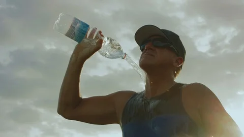 4K Man Cooling Down WIth Water After A Long Run Stock Footage