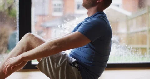4K Man doing exercises at home in front of the windows. Slow motion. Stock Footage 108489524