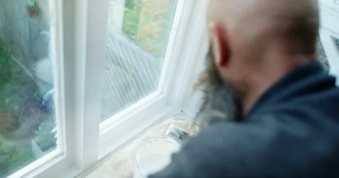 4K Man doing home renovations, painting interior window frames with white gloss  Stock Footage 88223590