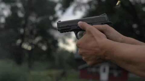 4K Man Fires 44mm Hand Gun Shooting Tight Shot Target Bullets Stock Footage 307128573